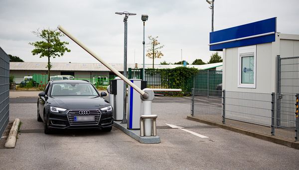 Black car passes through open barrier into the parking lot of Easy Airport Parking at Weeze Airport (NRN)